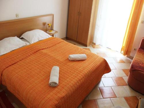 a bedroom with a bed with two towels on it at Apartments Pansion Franka 3 - Apartment 11 in Brist