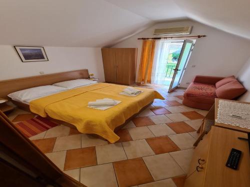 a bedroom with a bed with a yellow blanket at Apartments Pansion Franka 3 - Apartment 12 in Brist