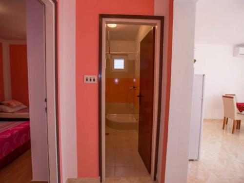 a bathroom with a shower and a door to a room at Apartments Zora - Standard One Bedroom Apartment with Balcony A1 in Lopar