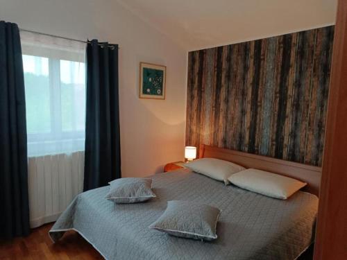a bedroom with a bed with two pillows and a window at Villa Hilda - Two Bedroom Villa in Barban