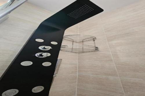 a black knife with buttons on it next to a basket at Apartment Gracac - Two Bedroom Apartment with Terrace in Gračac