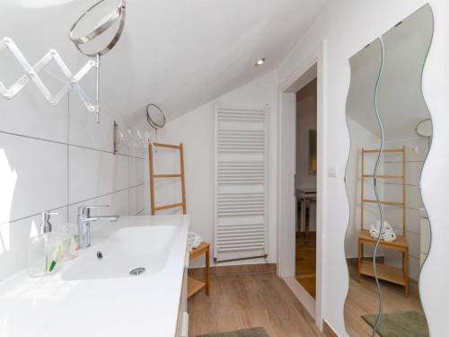 a white bathroom with a sink and a mirror at Spectacular Bol Island Sea View Villa with Pool - Four Bedroom Villa with Pool in Bol