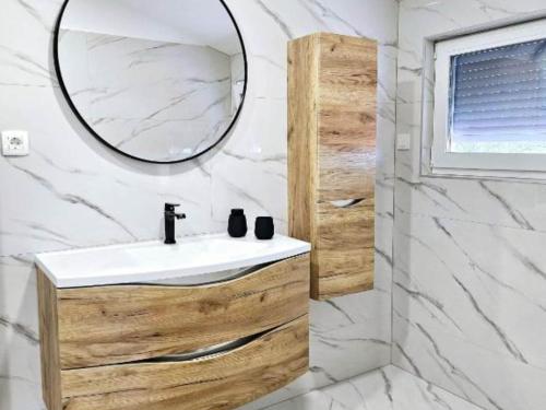 a bathroom with a sink and a mirror at Villa Nika - Three Bedroom Villa with Private Pool in Lozovac