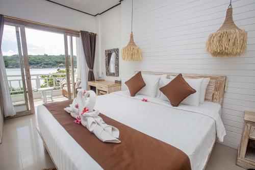 a bedroom with a bed with shoes on it at D'Pasih Private Villa in Nusa Lembongan