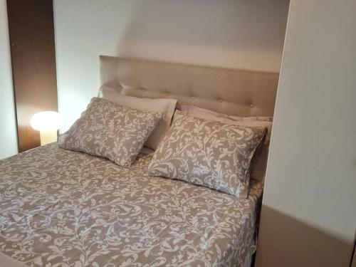 a bed with two pillows on top of it at Three bedroom Apartment with terrace and sea view in Postira