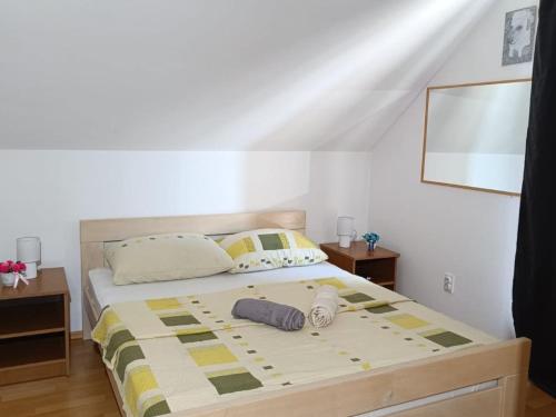 a bedroom with a bed with two towels on it at Apartmani Tea i Toni - Apartment Tea in Gradište