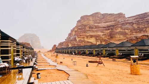 a view of a desert with a mountain in the background at Rum rose luxury camp in Wadi Rum