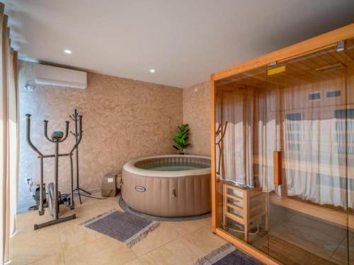 a large bathroom with a tub and a shower at Villa Breg - Four Bedroom Villa with Pool, Hot-Tub and Sauna in Kamešnica
