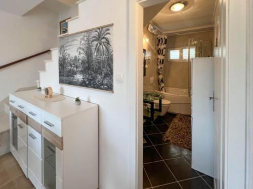 a bathroom with a sink and a refrigerator at Holiday Home Aurora - Three bedroom Holiday Home in Splitska