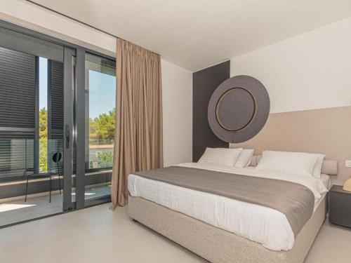 a bedroom with a large bed and a mirror at Four Bedroom Villa with pool in Vodice