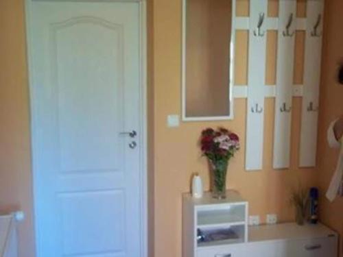 a room with a vase of flowers on a wall at One Bedroom Apartment with Balcony in Gajić
