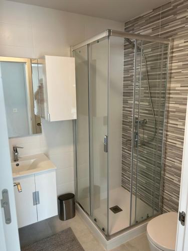 a bathroom with a glass shower and a sink at 3 Bedroom Villa La Segaria in El Verger