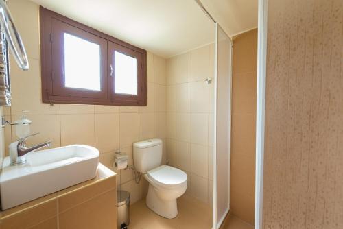 a bathroom with a toilet and a sink and a window at The old town Neighbourhood in Rhodes Town