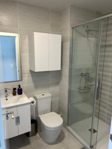 a bathroom with a toilet and a glass shower at Luxury Costa Blanca Villa near Denia with pool and roof terrace in El Verger