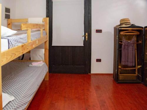 a room with two bunk beds and a door at Villa Bella - Two Bedroom House in Grožnjan