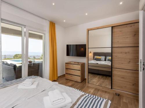 a bedroom with a bed and a large mirror at Villa Fran - Four Bedroom Villa with Private Pool in Šmrika