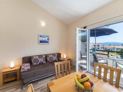 a living room with a couch and a table at Apartments Nmn - Studio Apartment with Balcony 2 in Drvenik