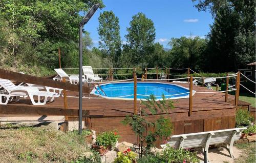 a swimming pool with chairs and a fence around it at Roselli in Roselli