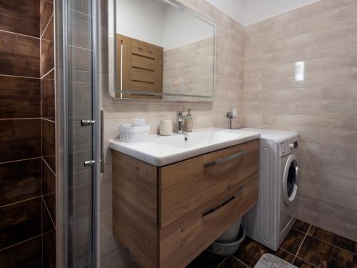 a bathroom with a sink and a washing machine at Holiday Home Milutin 1 - Four Bedroom Holiday Home with Private Pool in Vrsi