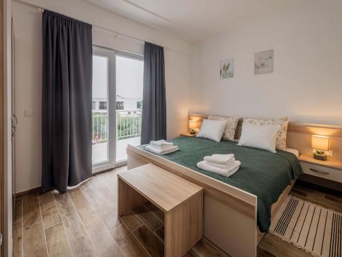 a bedroom with a large bed and a window at Holiday Home Milutin 1 - Four Bedroom Holiday Home with Private Pool in Vrsi