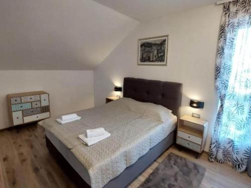 a bedroom with a large bed and a window at Villa Tamaris - Two Bedroom Holiday Home with Terrace and Swimming pool in Mali Drvenik