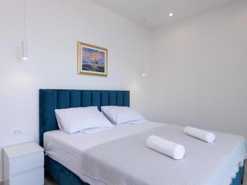 a bedroom with a bed with two pillows on it at Luxury Villa Navis - Villa in Rogotin
