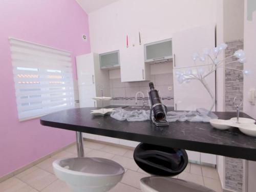 a kitchen with a table with a bottle of wine on it at Villa Ava - Five Bedroom Villa with Swimming pool in Šibenik