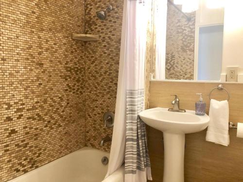 ein Badezimmer mit Waschbecken und Dusche in der Unterkunft Oceanfront Stay w/ AC, BBQ, Washer/Dryer & Kitchen in Ewa Beach