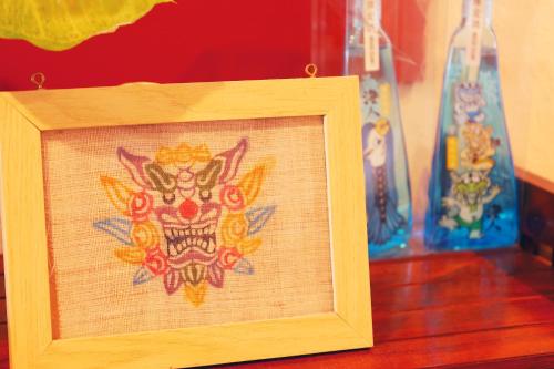a wooden picture frame with a drawing of a skull at 民宿さざんか in Okinawa City