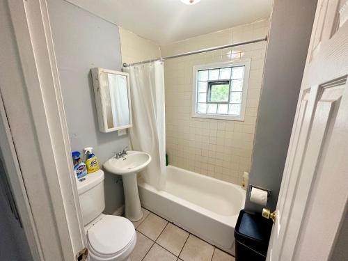 a bathroom with a sink and a toilet and a bath tub at Amazing Place to stay near Downtown Chicago! in Chicago