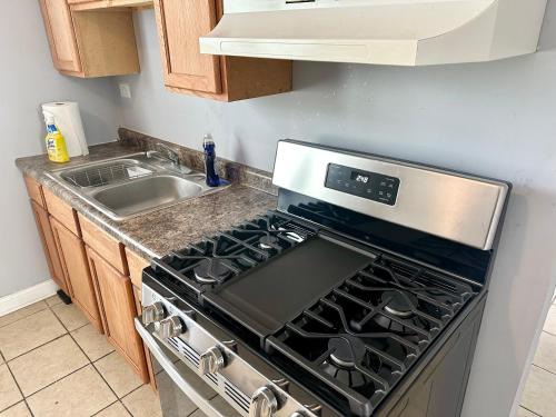 a kitchen with a stove and a sink at Amazing Place to stay near Downtown Chicago! in Chicago