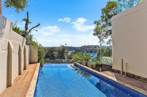 a swimming pool in the backyard of a house at 6BR Stunning Waterview & Private Pool in Sydney