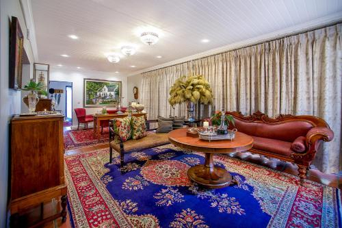 a living room with a couch and a table at Batavia Boutique Hotel in Stellenbosch