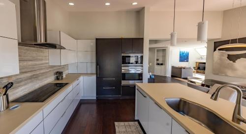 a kitchen with white cabinets and a black refrigerator at Vail in Vail