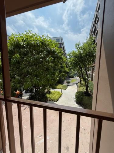a balcony with a view of a tree and a sidewalk at Spacious 1 Bedroom, with sofa bed and Balcony in Kathu