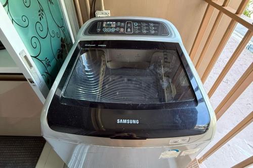a toaster oven is sitting in a room at Spacious 1 Bedroom, with sofa bed and Balcony in Kathu