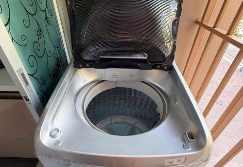 a silver toilet with the seat up in a room at Spacious 1 Bedroom, with sofa bed and Balcony in Kathu