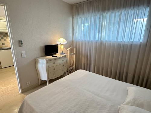 - une chambre avec un lit et un bureau avec un ordinateur dans l'établissement Appartement spacieux avec terrasse vue port, parking inclus - FR-1-252A-133, à Villeneuve-Loubet