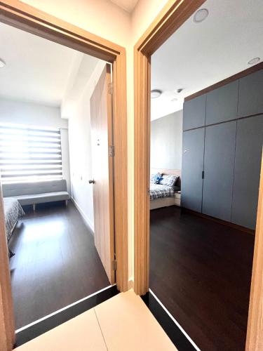 an empty room with a door open to a bedroom at Kirakuan Luxury 2BR Pool/Gym in Ho Chi Minh City