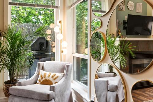 a room with two chairs and a mirror at The Velvet Fern Guesthouse in Courtenay