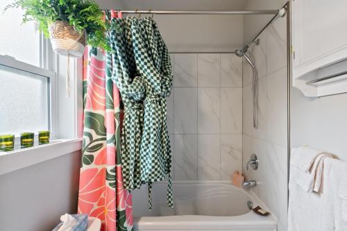 a bathroom with a shower with a shower curtain at The Velvet Fern Guesthouse in Courtenay