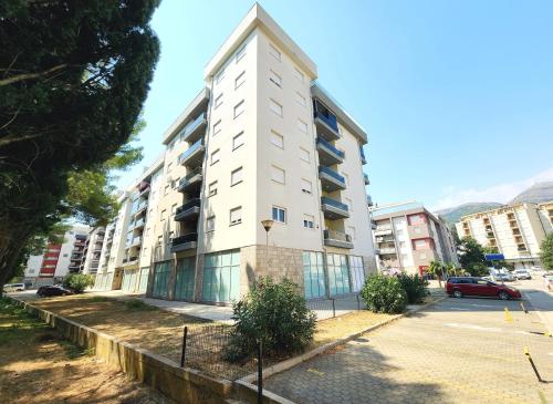 a tall white building on a city street at Apartment Bella Vista in Trebinje