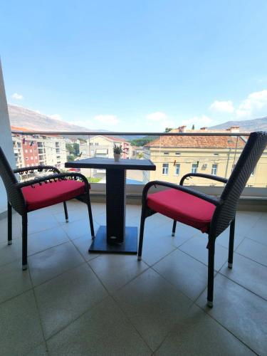 two chairs and a table on a balcony with a view at Apartment Bella Vista in Trebinje