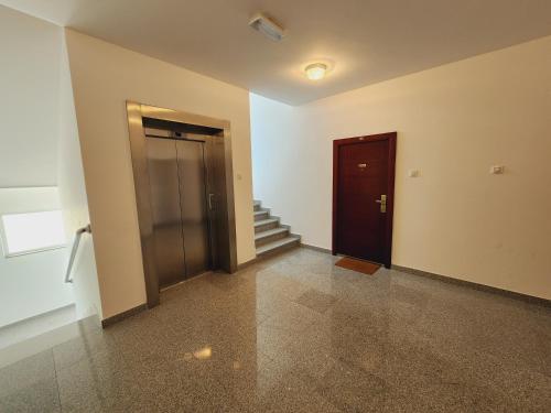 a hallway with a door and stairs in a building at Apartment Bella Vista in Trebinje