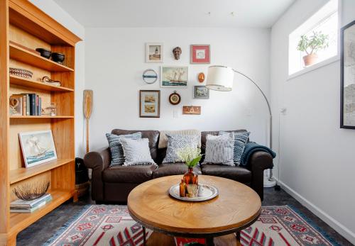 a living room with a couch and a table at Sleepy Owl Chalet 