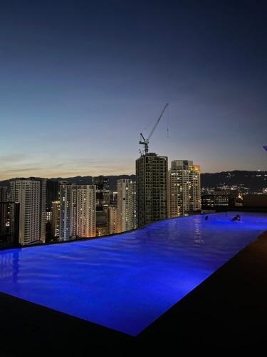 a view of a city at night with blue lights at Calyx Residences in Cebu City