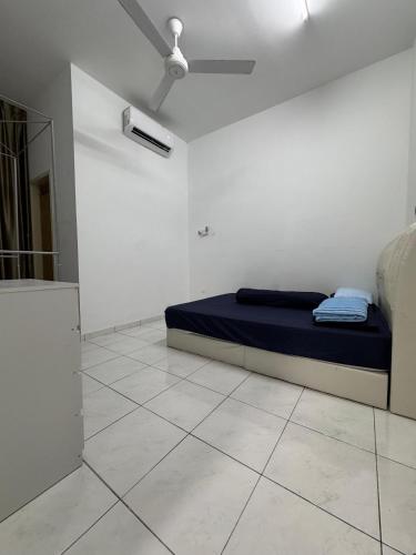 a bedroom with a bed in a white room at Homestay D BBSE in Simpang Empat