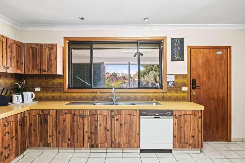 a kitchen with a sink and a window at Comfort & Calm - Double Room on a Quiet Crescent in Liverpool - Shared Bathroom in Liverpool