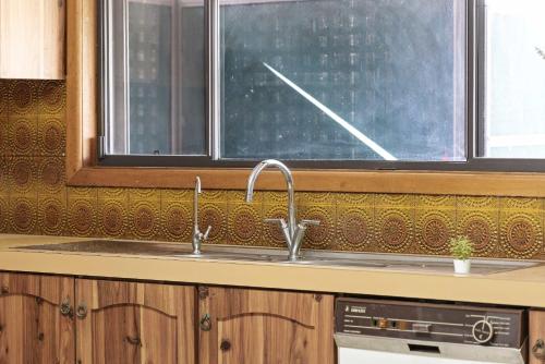 a kitchen with a sink and a window at Serene and Spacious King Room in Liverpool - Quiet Yet Central - Shared Bathroom in Liverpool