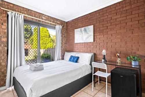 a bedroom with a bed and a window and a chair at Quiet Crescent Stay in Liverpool - Comfortable Double Room - Shared Bathroom in Liverpool